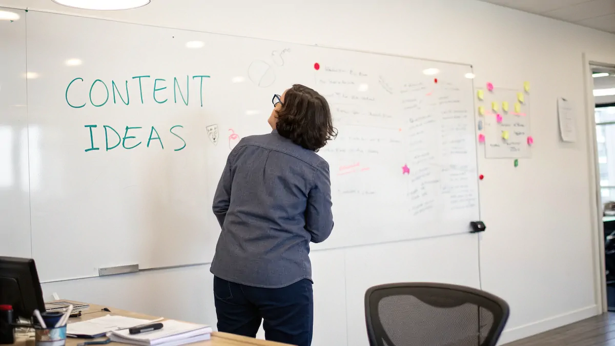 A person standing in front of a whiteboard with a list of content ideas, symbolizing the importance of content for a website