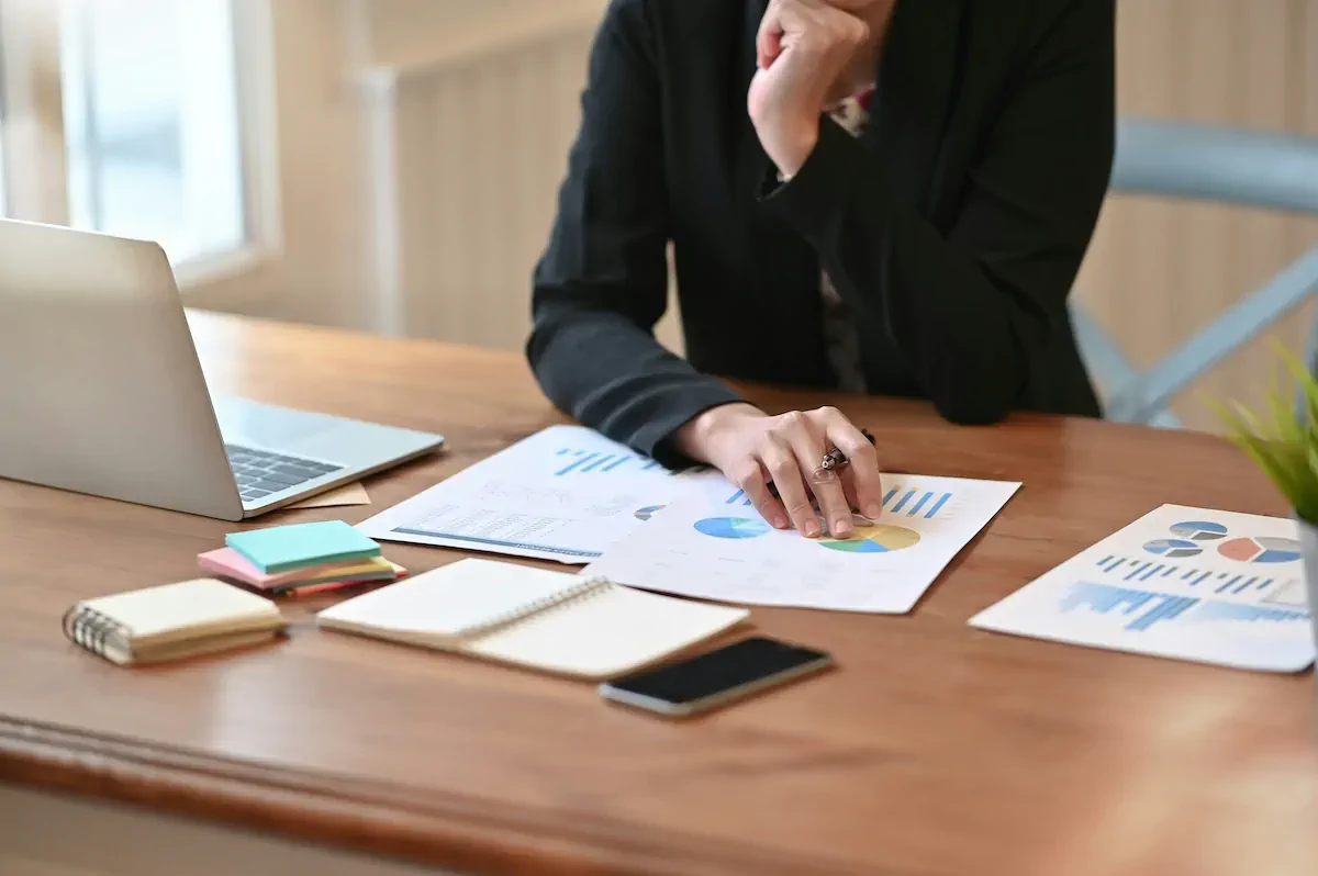 A checklist showing communication requirements with checkmarks and a professional project manager reviewing them